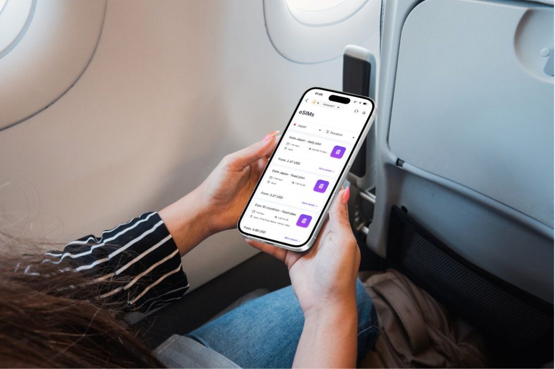 Traveler on a plane browsing Fizen eSIM plans in the Super App